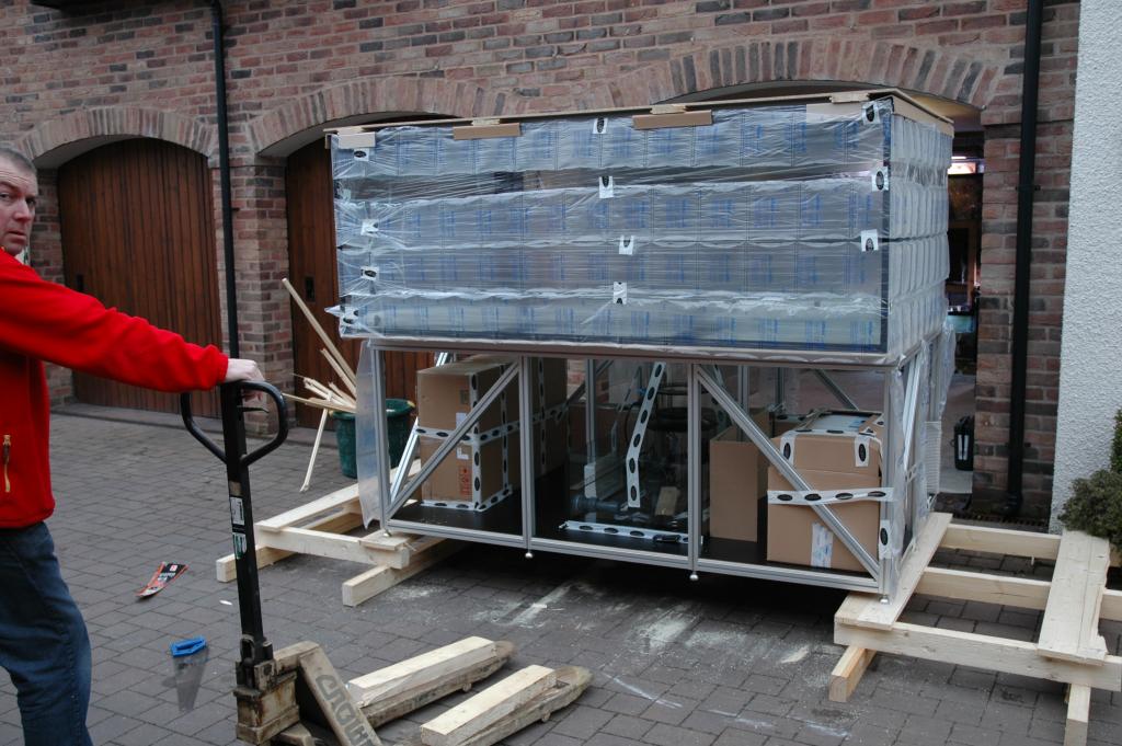 The solution to getting the tank off the pallet was to cut the pallet in two then jack up the middle and move the pallet to the ends. Once in this position we lowered it to the floor by reducing the height of the wood at either end in stages.